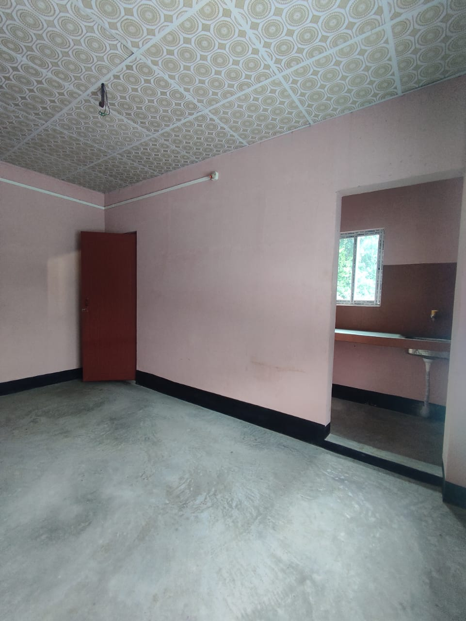 A single room with attached bathroom and kitchen